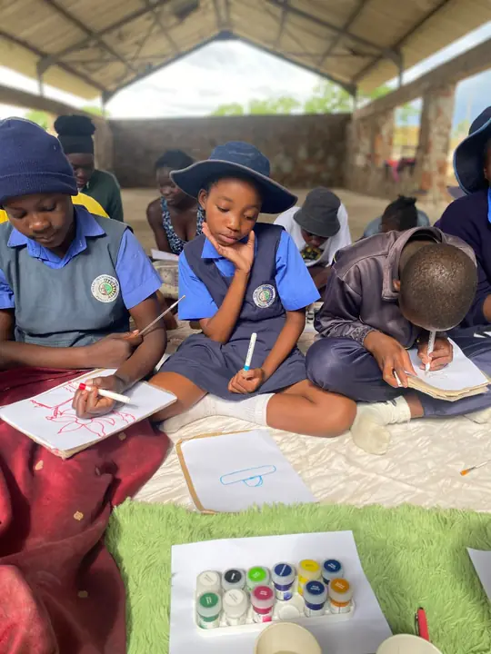 Girls drawing and writing together during the CTT Exhale Circle